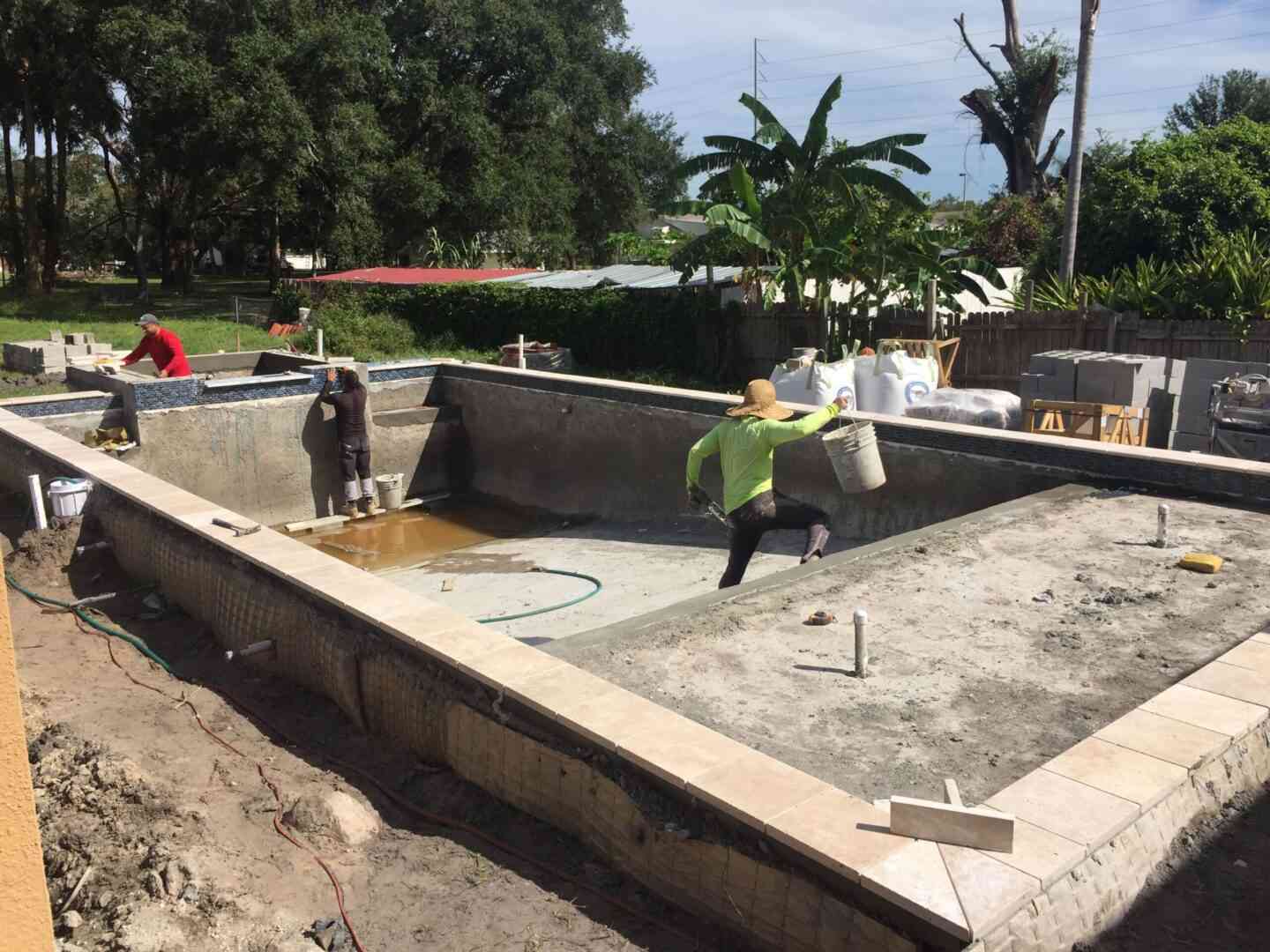 Construction workers building a pool