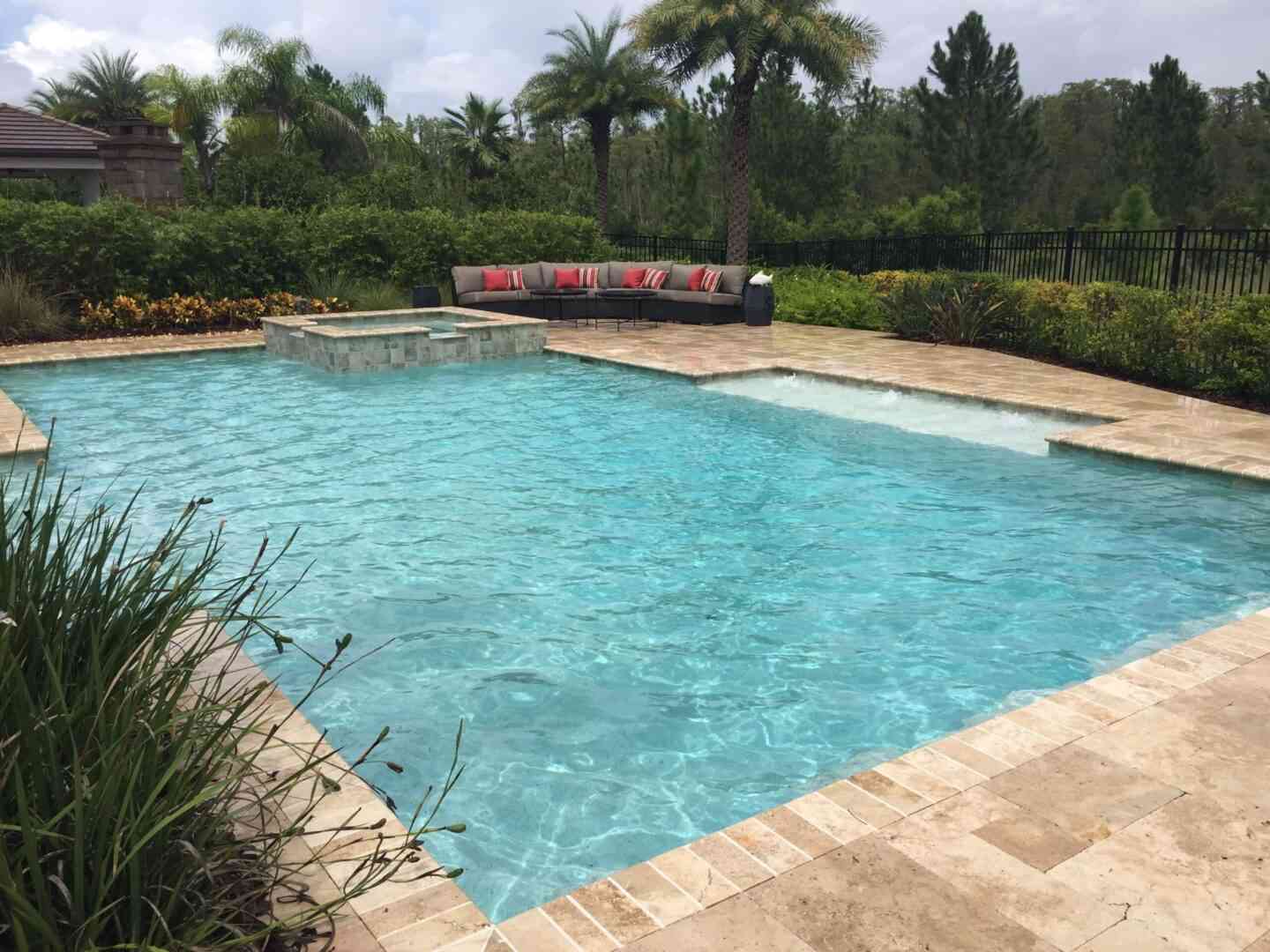 A large outdoor pool with a lounge area